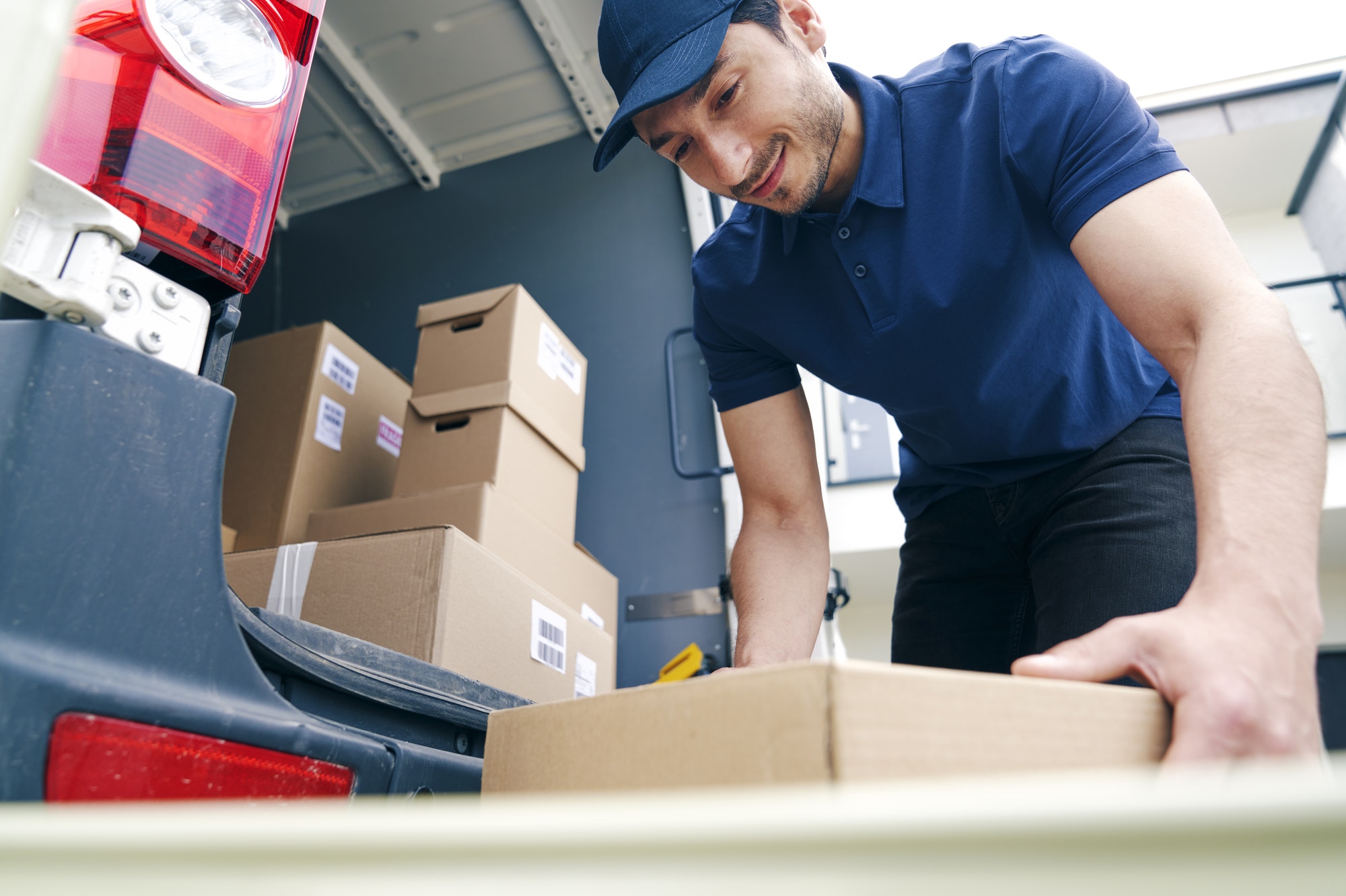 courier-unloading-packages-on-the-hand-truck.jpg