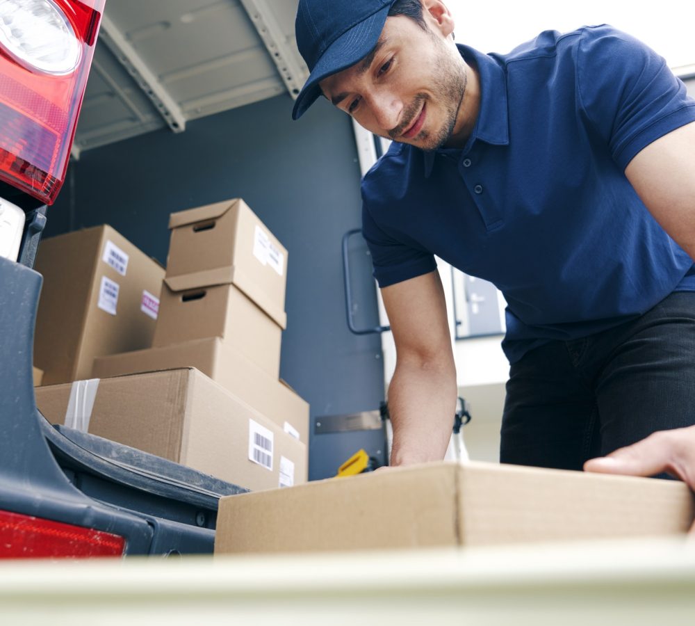 courier-unloading-packages-on-the-hand-truck.jpg